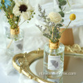 Ronde fles riet diffuser met boeketbloemen
